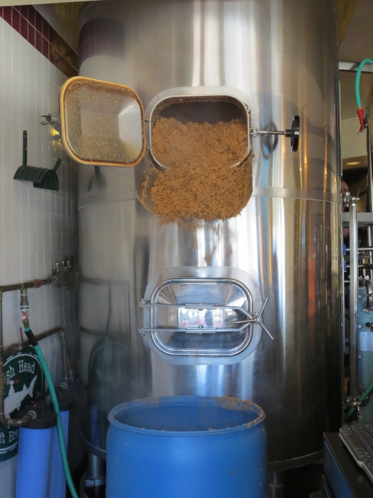 Spent grain is stored in large barrels and reused as cattle feed.