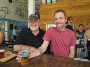 David Keller strikes a pose with me while showing off his Peddler Brewing tattoo.