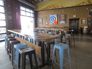 Long community tables are provided in the spacious indoor section of the tasting room as well as bar seating.
